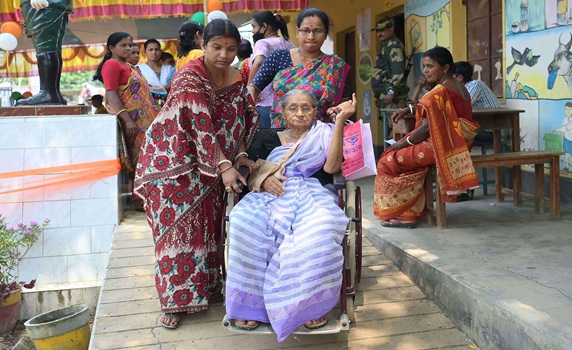 A visually challenged elderly lady is seen in a queue to cast her vote for the second phase of Lok Sabha elections in Teliamura. PIC- Abhisek
