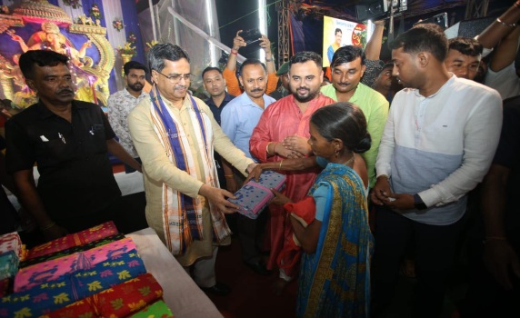 Chief Minister Dr. Manik Saha embraces the spirit of giving as he presents sarees to underprivileged women during the Sri Sri Ganesh Puja celebration in Bishalgarh Mandal