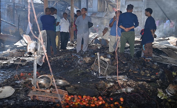 Shop owners and vendors were seen in front of their burnt shops and vegetables last night at Battala Market in Agartala. The fire destroyed 155 shops; the estimated loss is expected to exceed Rs 2 crore.