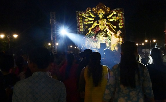 Devotees join Durga Puja Carnival in Agartala, immersing award-winning idols in Howrah River procession.