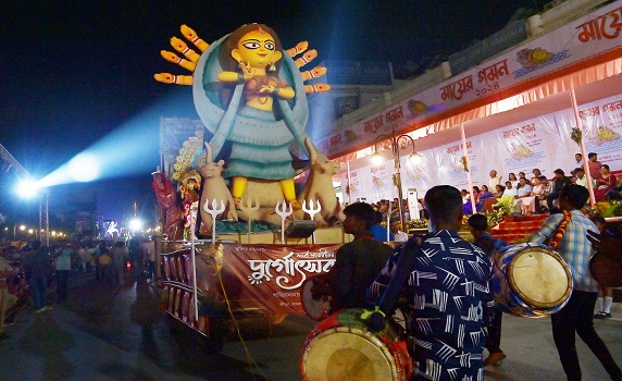 Devotees join Durga Puja Carnival in Agartala, immersing award-winning idols in Howrah River procession.