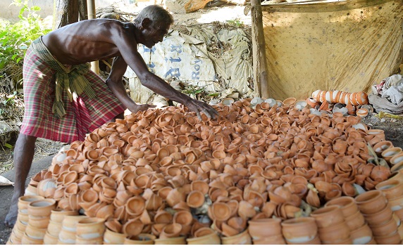 Potter arranges earthen lamps in oven as Diwali preparations begin for the Hindu festival of lights. PIC- Abhisek 