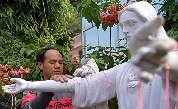 A worker cleans a statue of Jesus Christ in the Don Bosco Church ahead of Christmas at Agartala. PIC- Abhisek