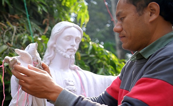 A worker cleans a statue of Jesus Christ in the Don Bosco Church ahead of Christmas at Agartala. PIC- Abhisek