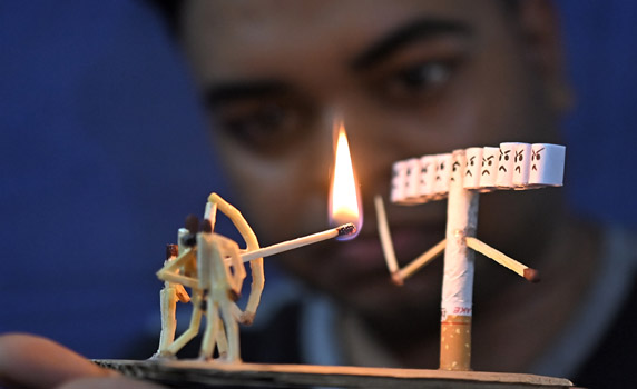 Bijoy Debnath,( 21) and his art works  for "Quit Mmoking" campaign on the eve of No Tobacco Day .  PHOTO-ABHISEK SAHA.